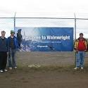 The team in front of a Wainwright sign.